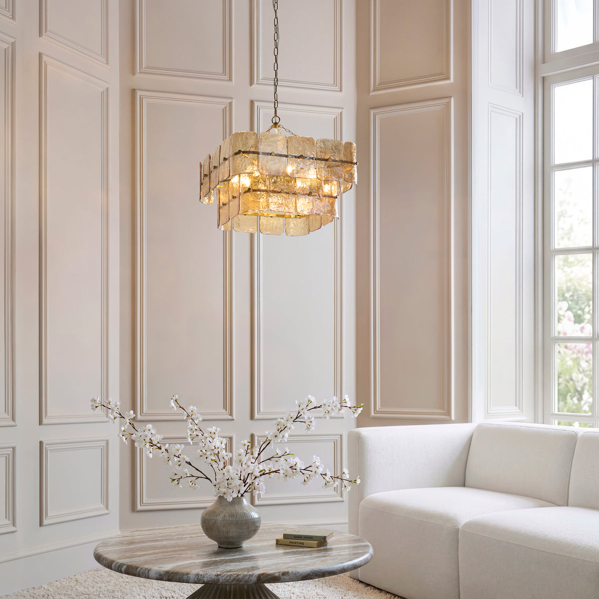 Venice champagne glass chandelier illuminated in a bright panelled living space