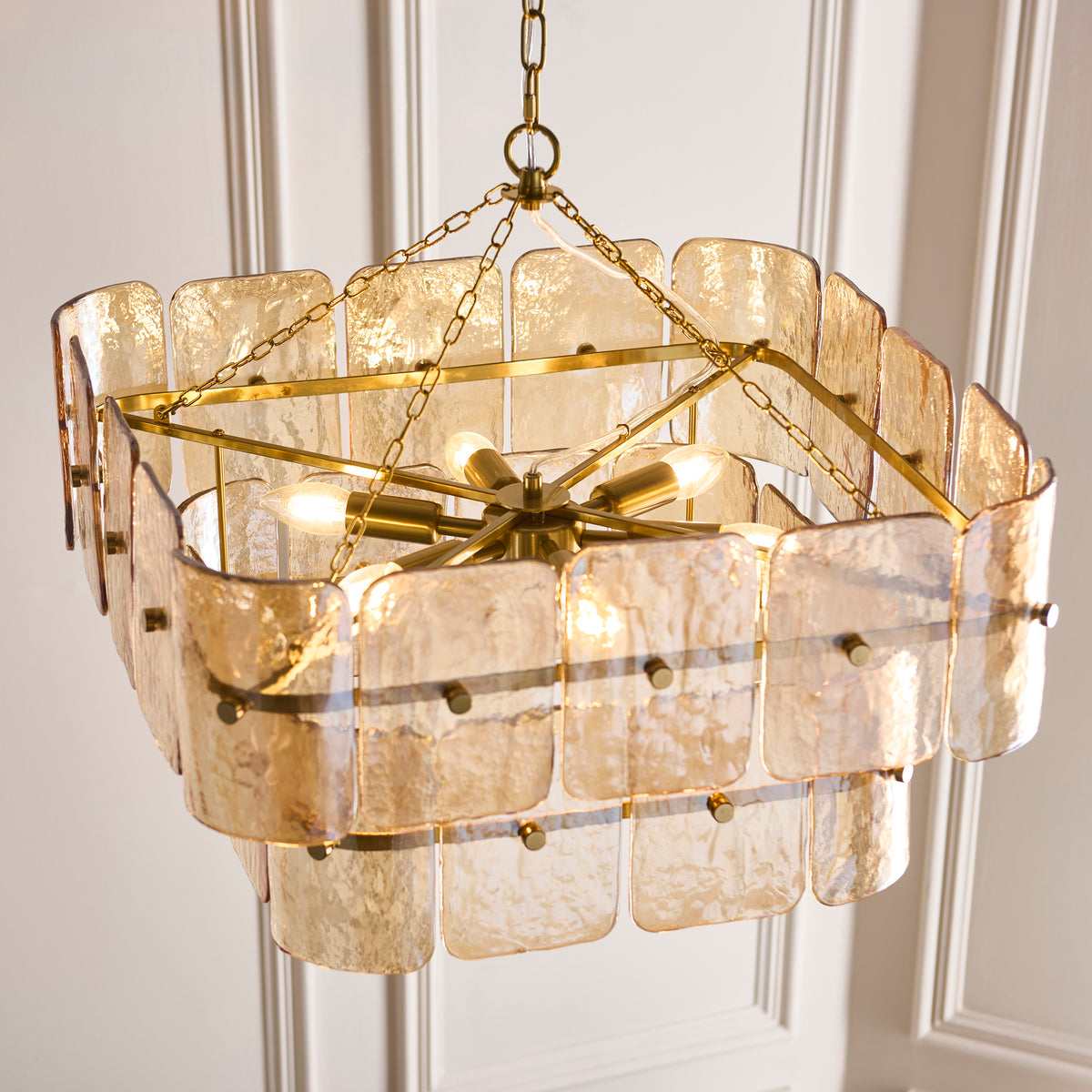 Interior of the Venice chandelier showing brass arms, lamp holders and warm bulbs