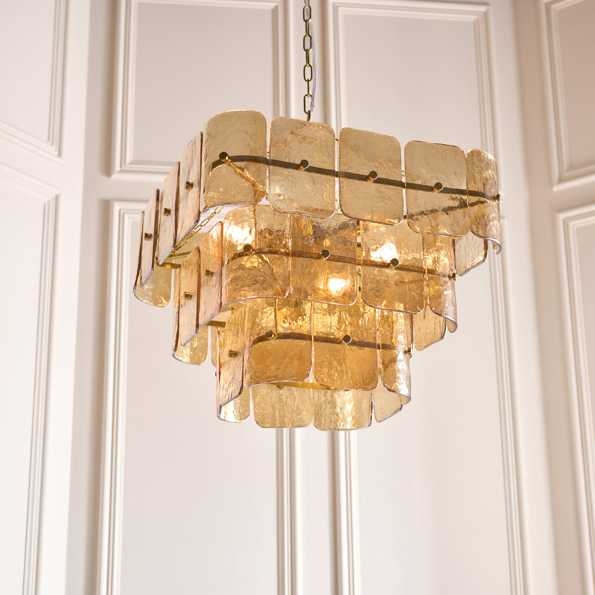 Angled view of the Venice pendant's stepped tiers of champagne textured glass panels