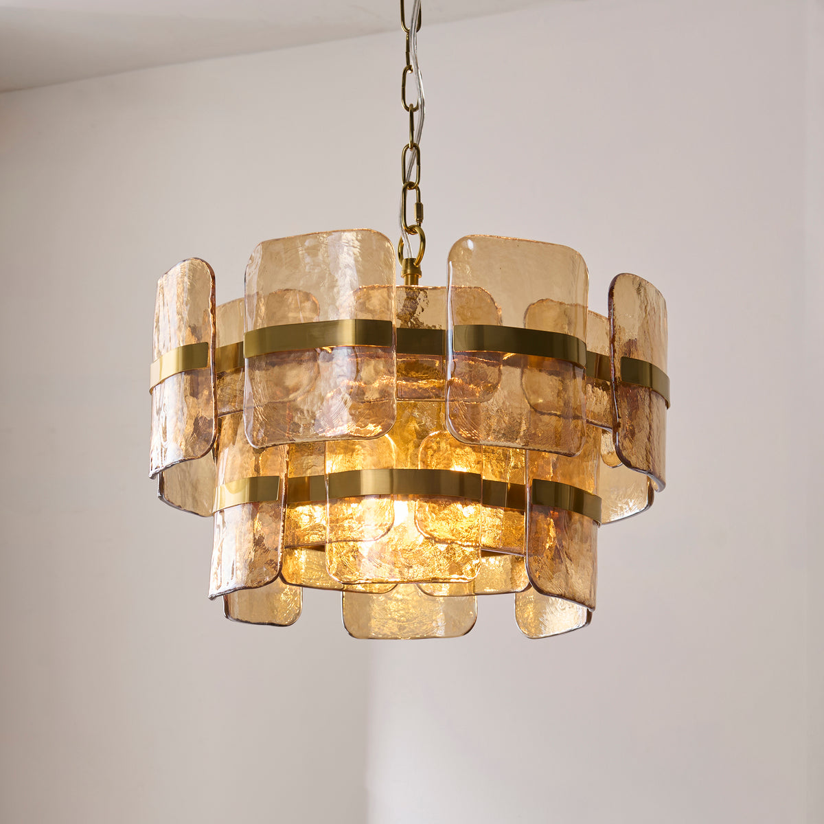 Ancara champagne glass pendant seen from below, showing two tiers of overlapping textured panels