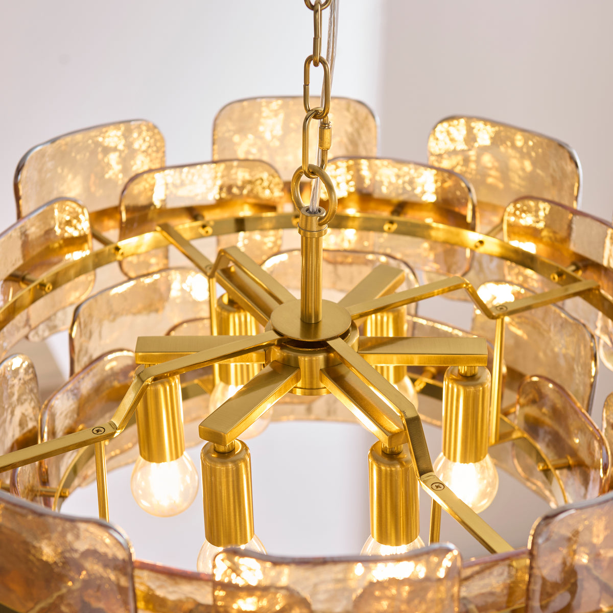 Underside of the Ancara 6 light pendant with brass spoke frame, six lamps and glass panel tiers
