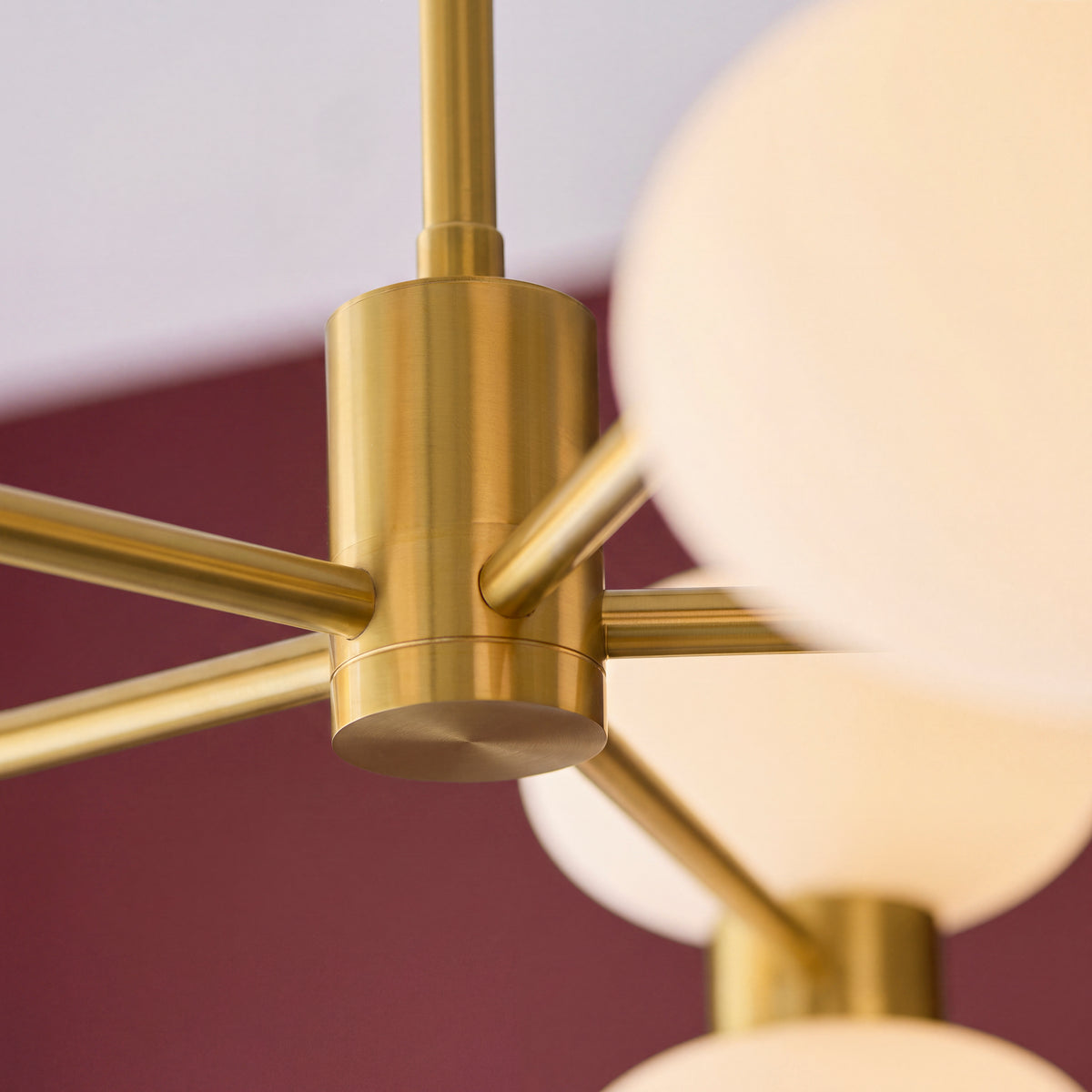 Detail of the brushed brass hub and arms at the centre of the Rossano pendant