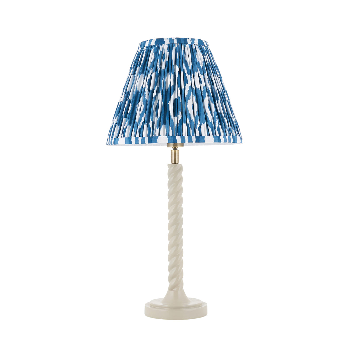 Twist & Ikat almond white table lamp complete with its blue ikat pleated shade