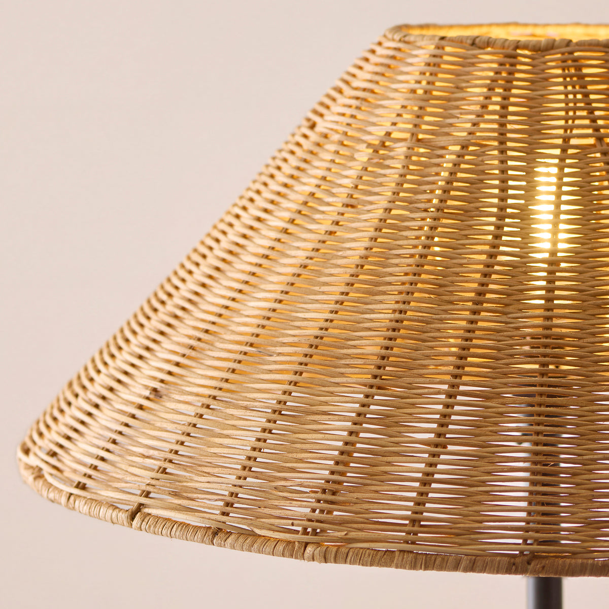 Detail of the open weave of the natural brown rattan shade glowing from within