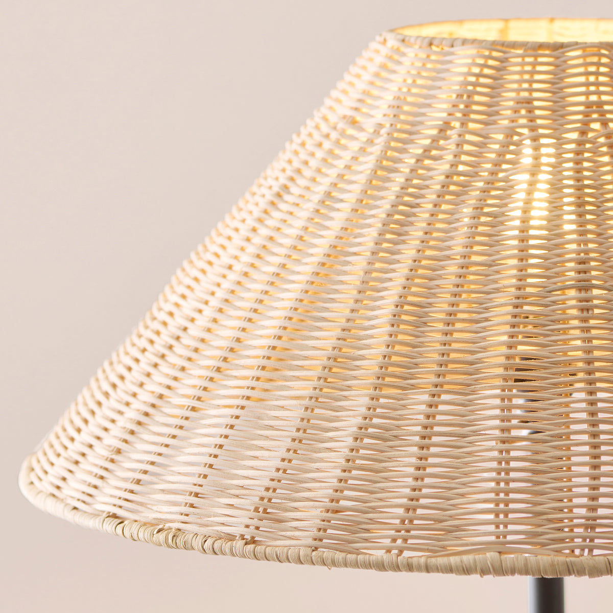 Detail of the fine natural rattan weave of the Arlo shade, softly backlit
