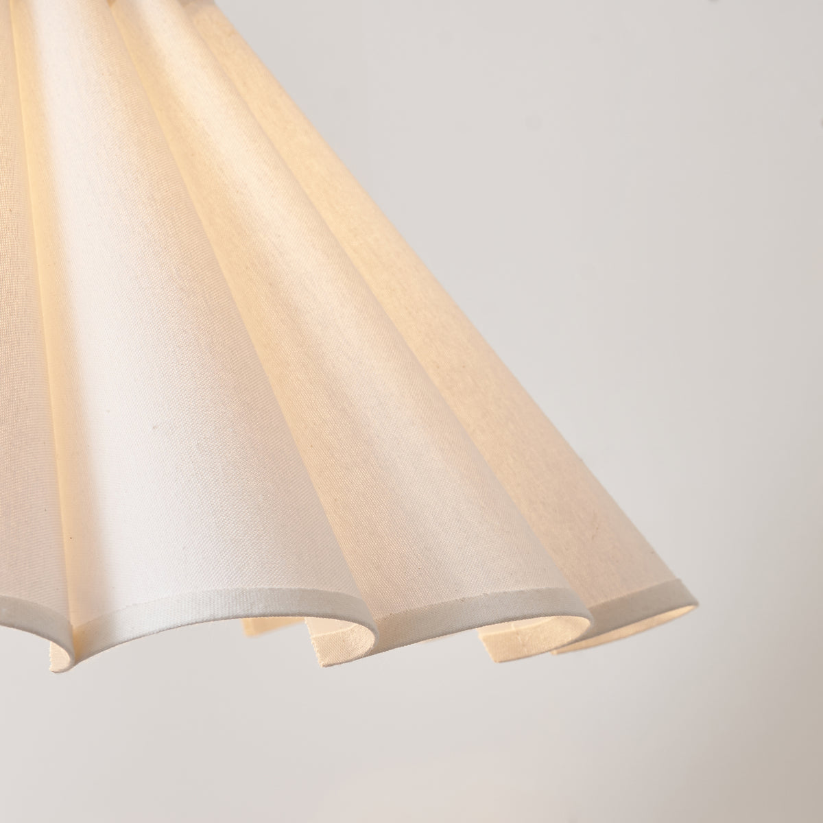 Detail of the fluted lower edge of the ivory pleated shade on the Arlo & Ayla lamp