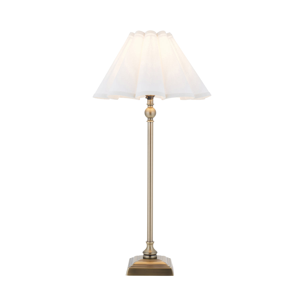 Sylvie table lamp in antique brass with a stepped square base and white scalloped shade