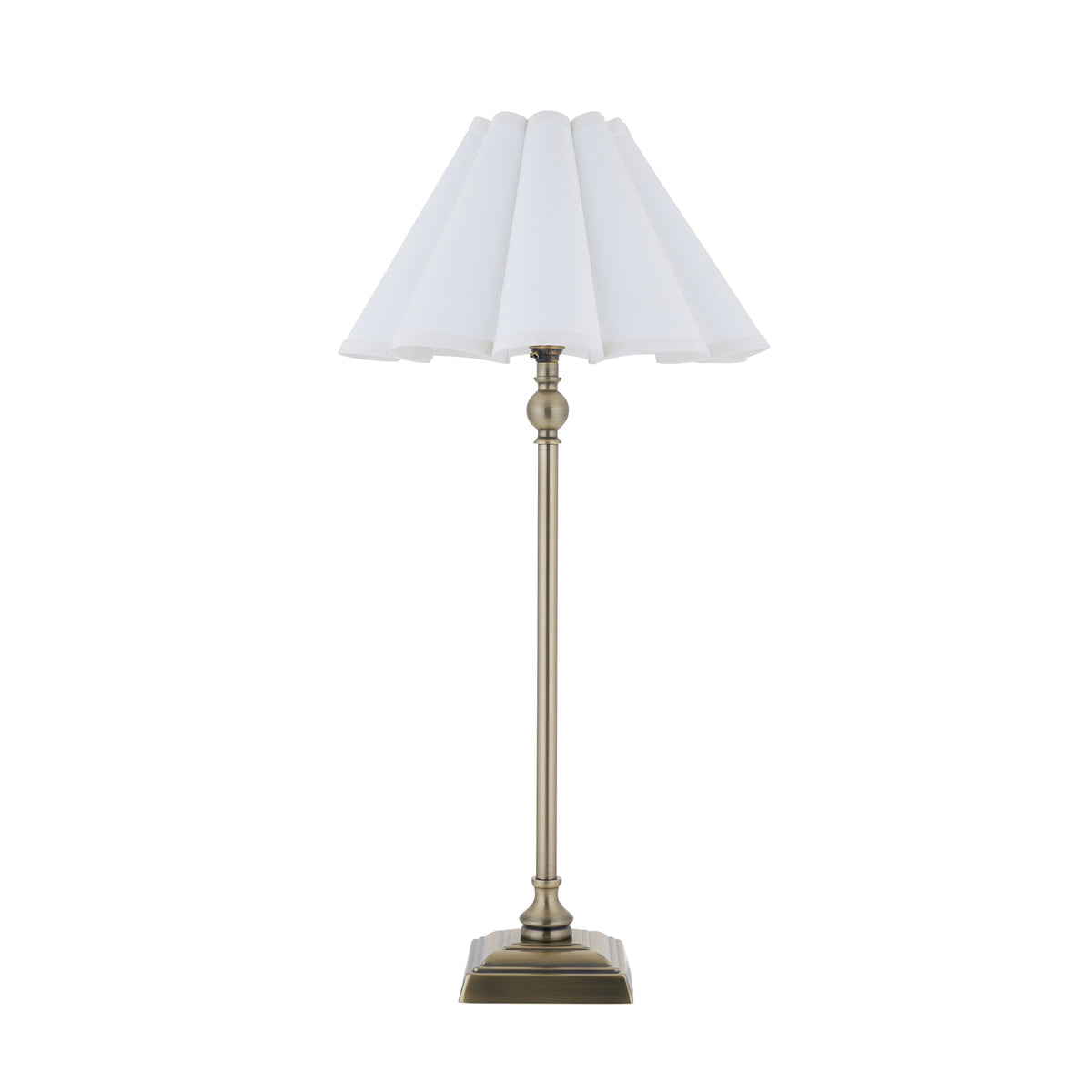 Sylvie antique brass table lamp with white scalloped shade shown unlit against white