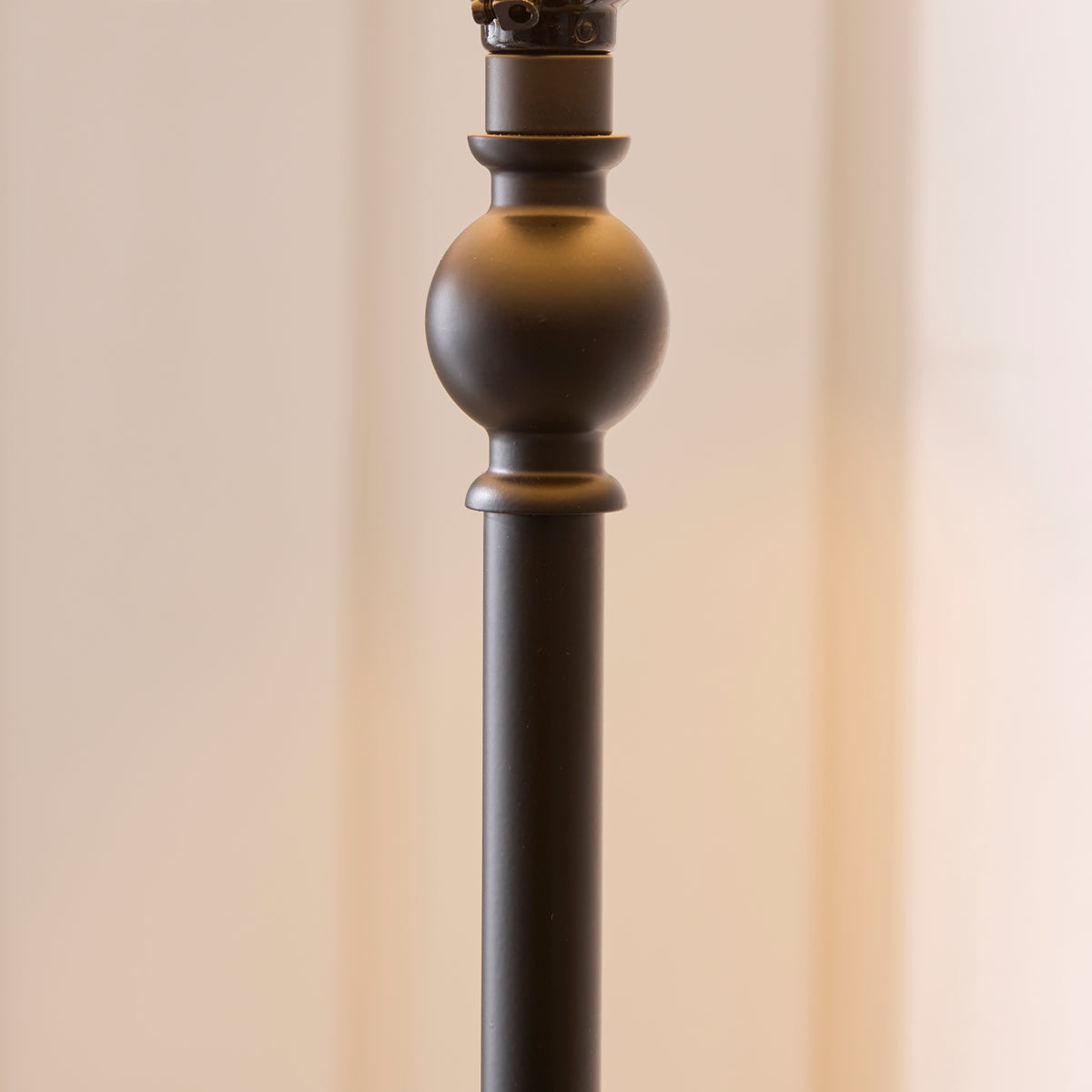 Detail of the matt black turned stem and ball collar on the Sylvie floor lamp