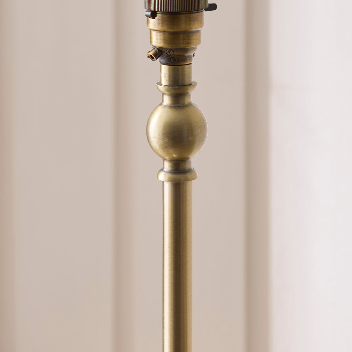 Detail of the antique brass stem, ball collar and lampholder on the Sylvie floor lamp