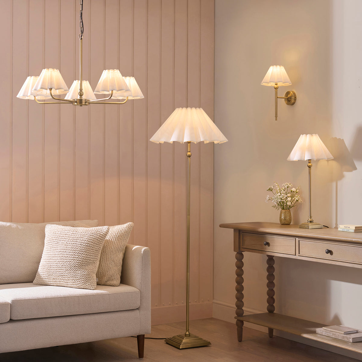 Sylvie brass collection in a living room with chandelier, floor lamp, wall light and table lamps