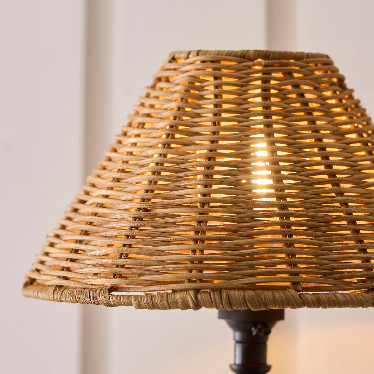 Detail of the Jericho light's natural rattan weave glowing with the lamp shining through