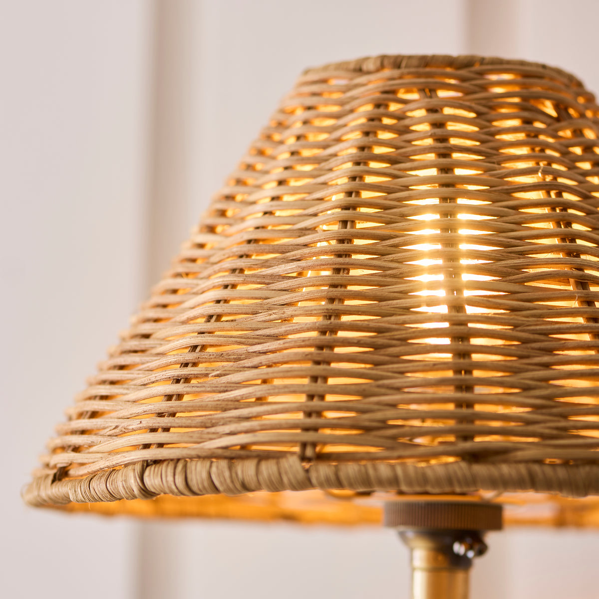 Close-up of the natural rattan weave on the Jericho wall light's shade with light showing through