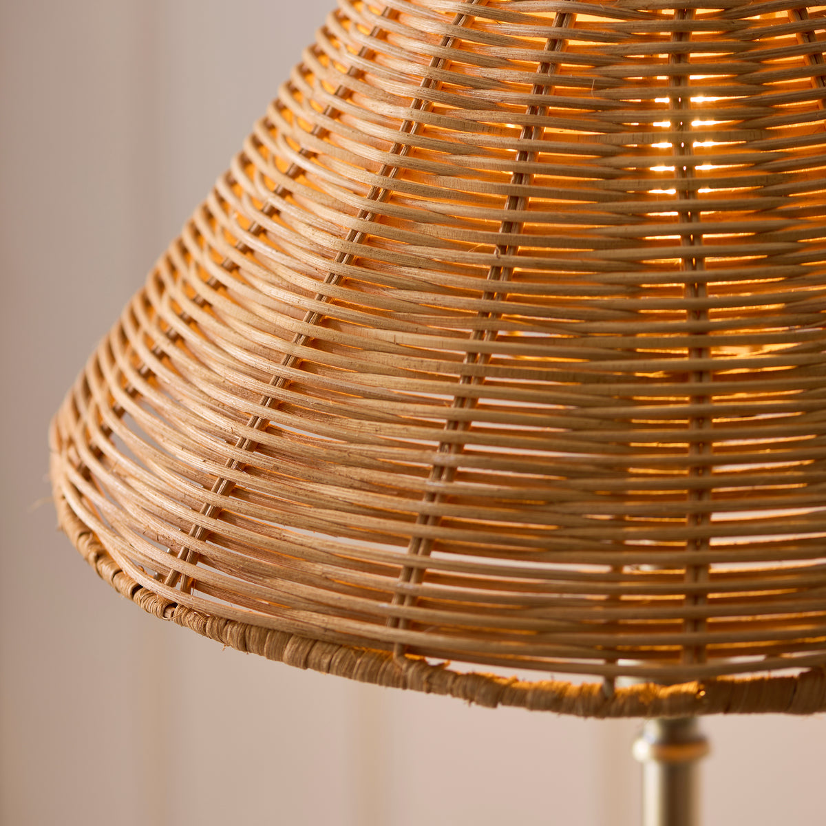 Detail of the woven rattan weave on the Jericho table lamp's shade with warm light behind