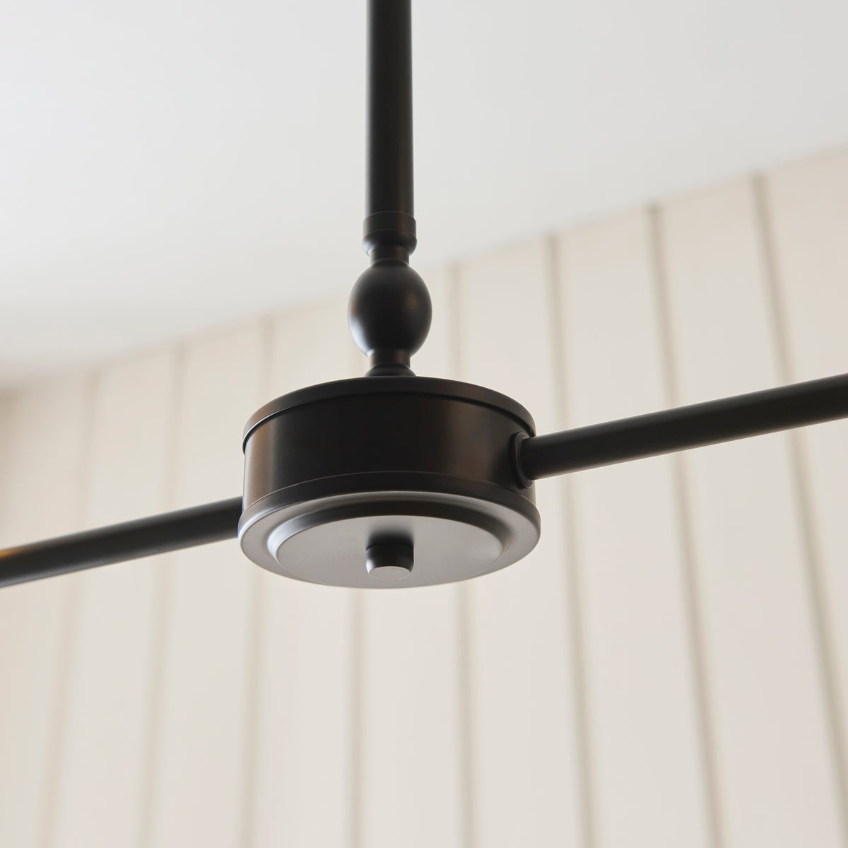 Underside of the Jericho linear pendant's black central housing and arms