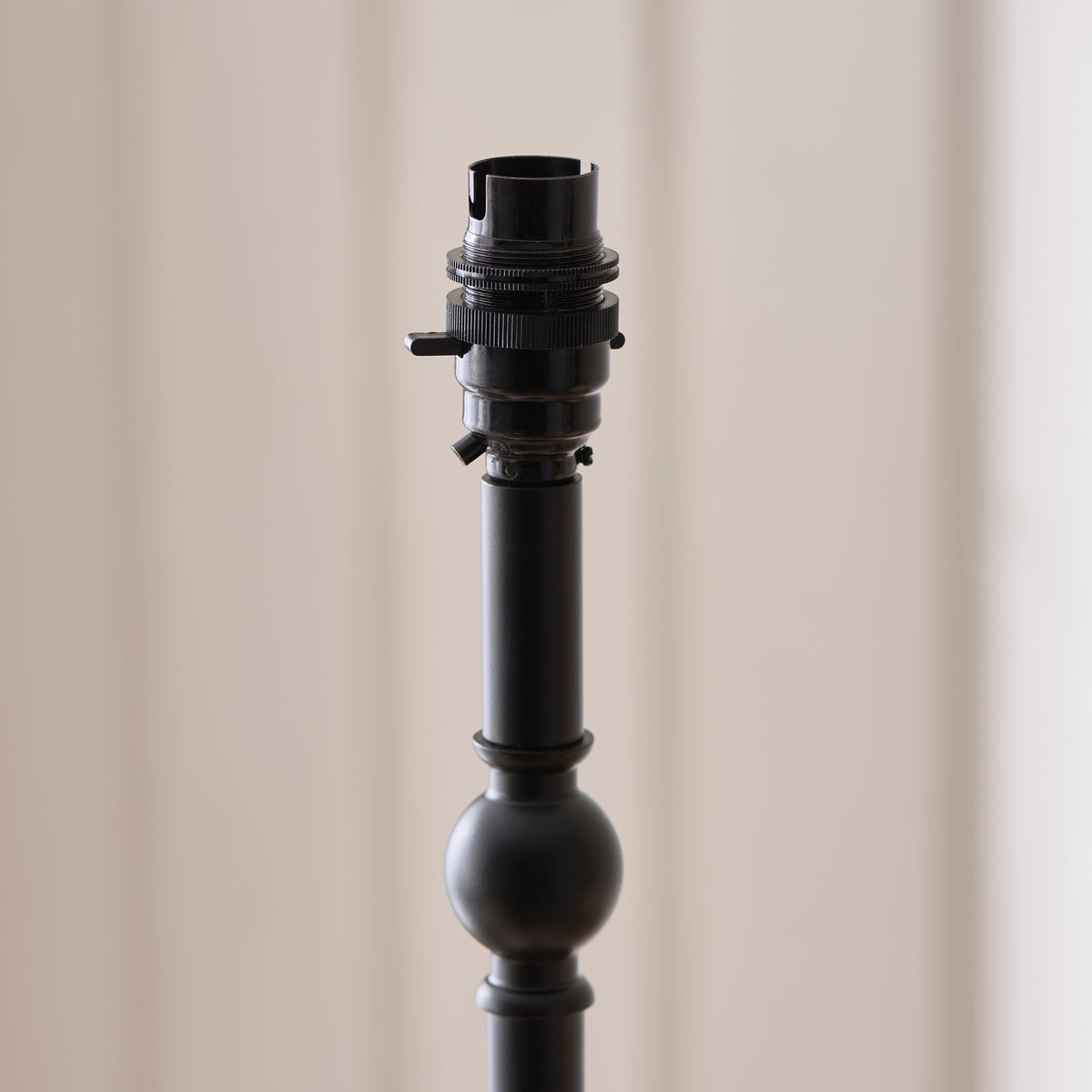 Black turned stem and bulb holder of the Jericho table lamp without its shade