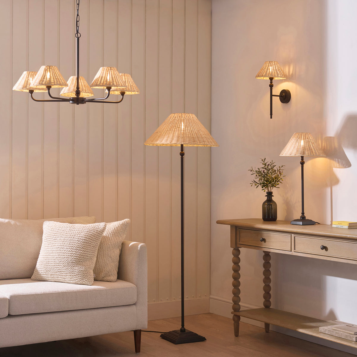 Jericho rattan range in a living room: black chandelier, floor lamp, wall light and table lamps