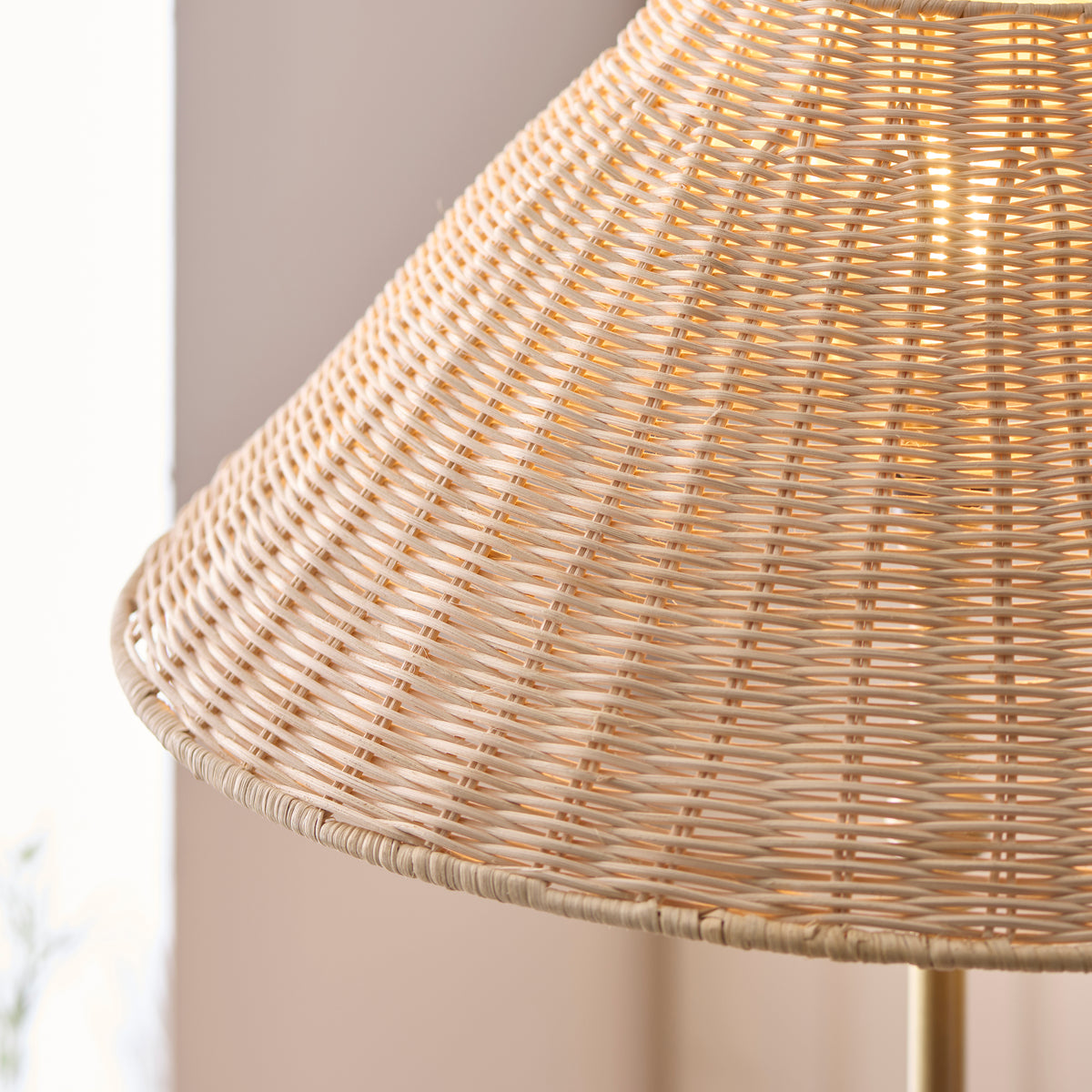 Close-up of the woven rattan shade on the Jericho brass floor lamp, light through the weave