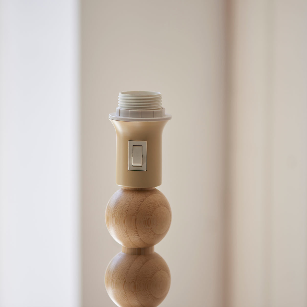 Detail of the Cane & Leaf lamp's bamboo lampholder with rocker switch and ball stem
