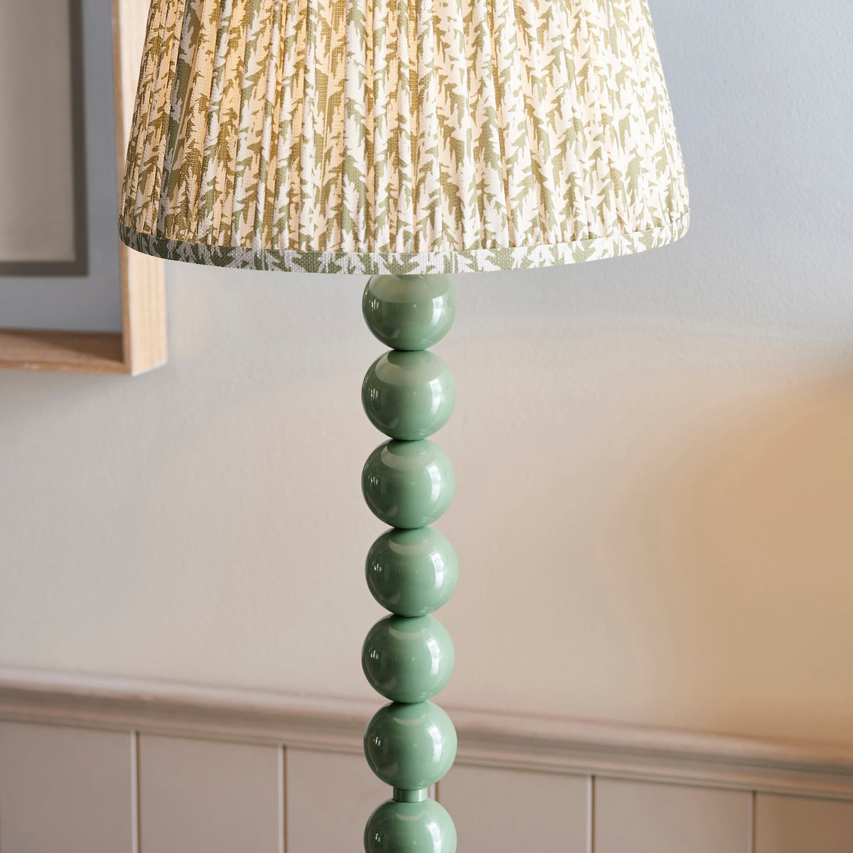 Detail of the glossy Cotswold green stacked spheres forming the Higgledy floor lamp stem