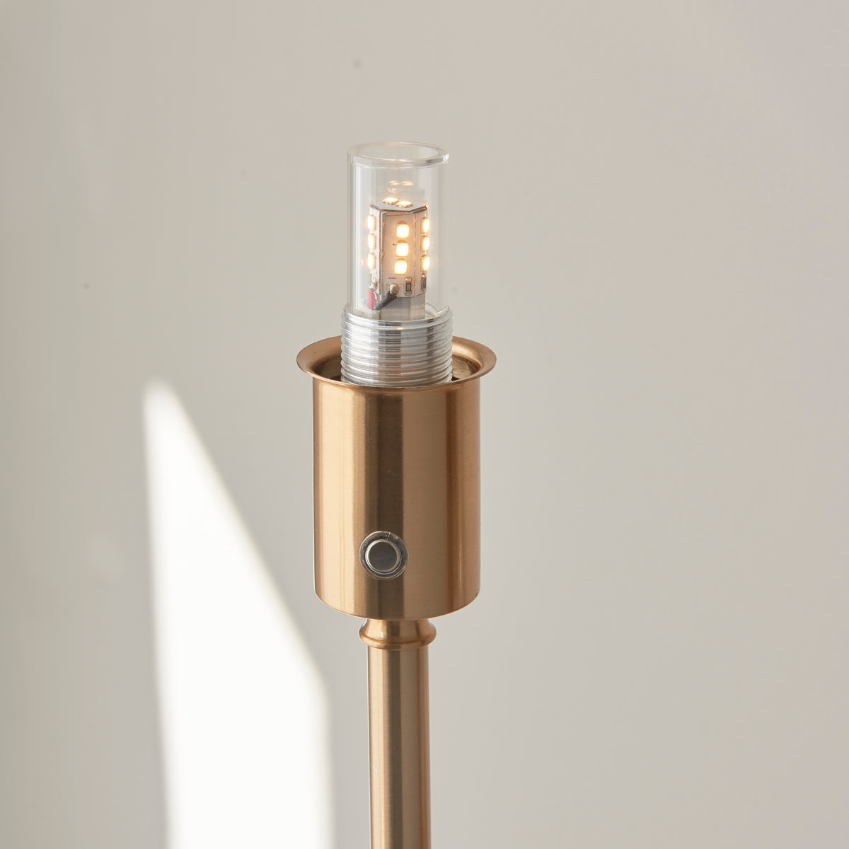 Brass lamp head of the Burley floor lamp with LED bulb and rechargeable push switch