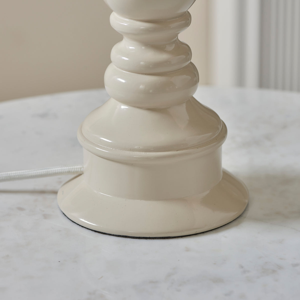 Foot of the Myrtle almond white lamp base standing on a marble surface