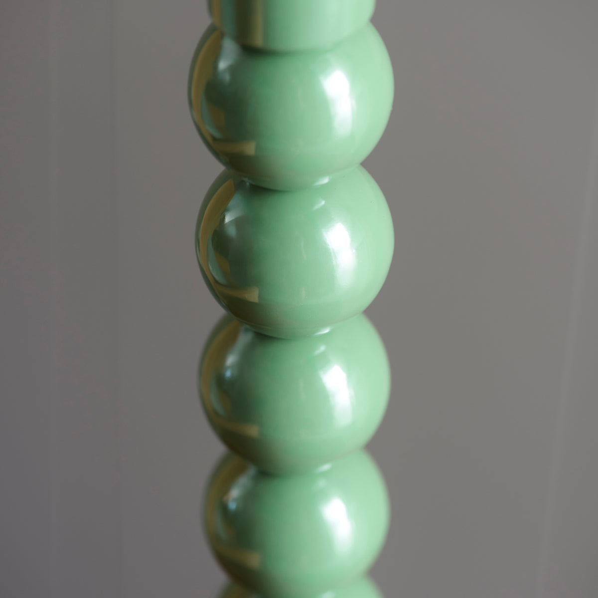 Detail of the glossy green stacked spheres on the Higgledy table lamp stem