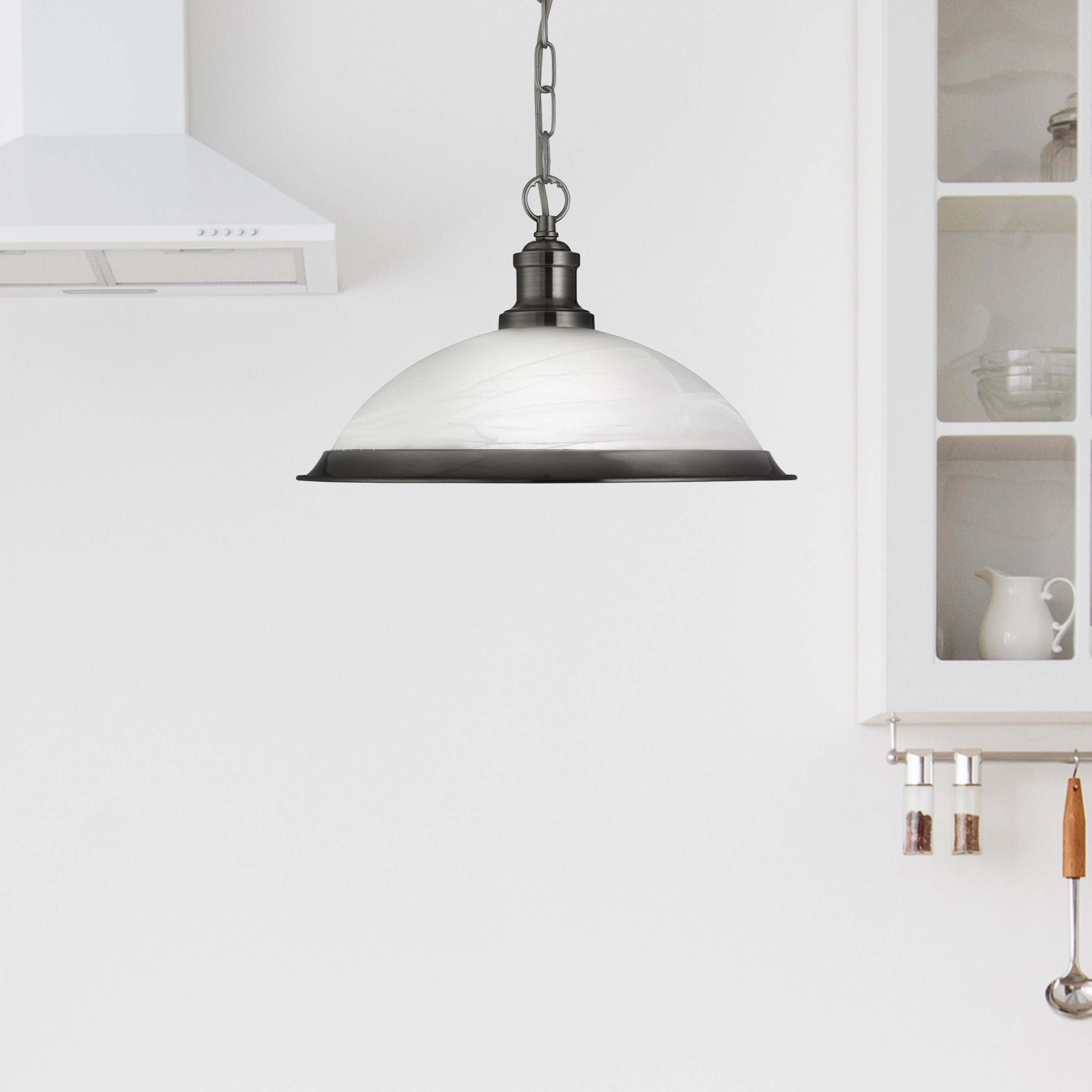 Pendant light fixture in a kitchen setting with white cabinets and a neutral color scheme.