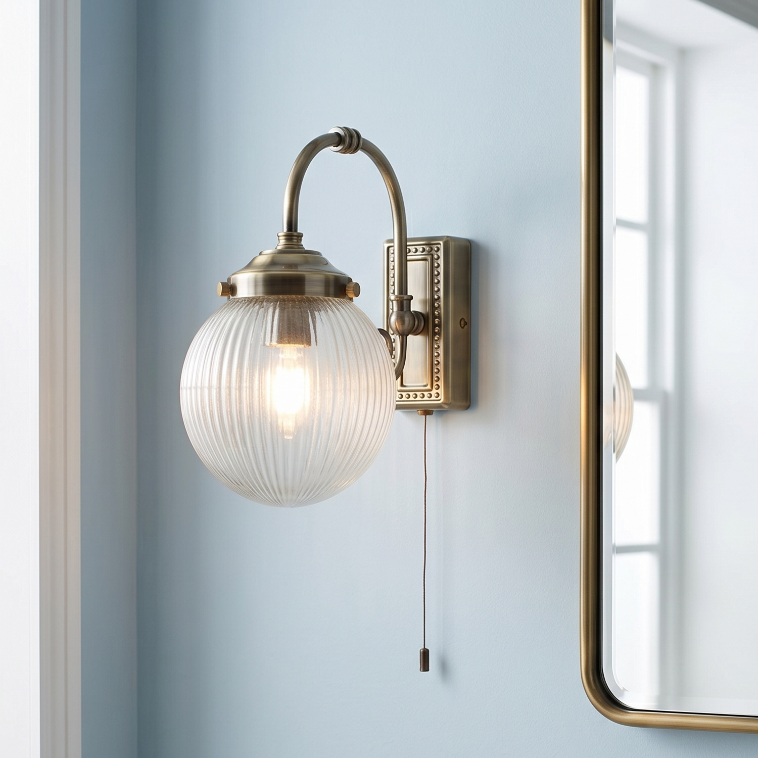 Belvue 1 Light Brass Bathroom Wall Light, Clear Globe Shade
