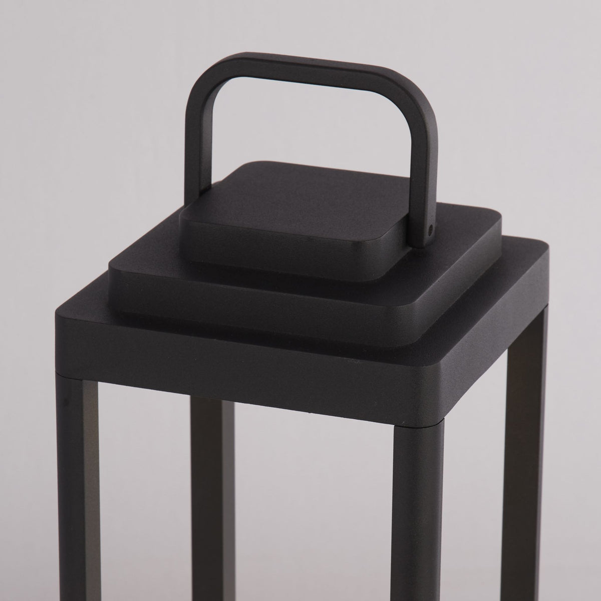 Close-up of the Portobello lantern's stepped matt black top and looped carry handle