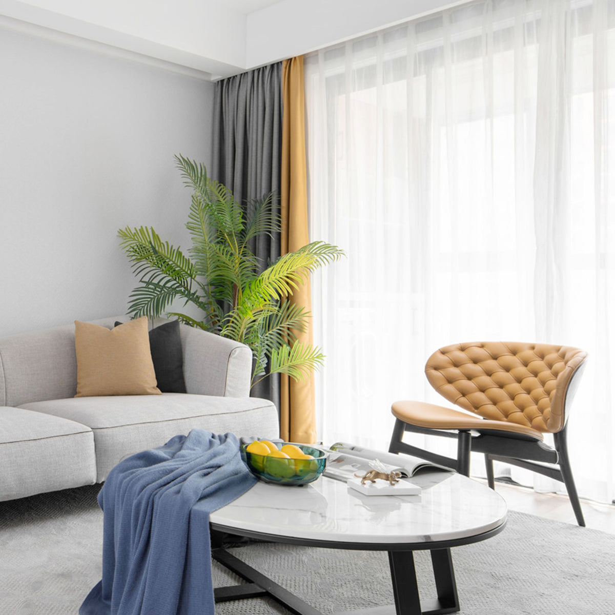 Living room with the Ringo black LED ceiling light above a grey sofa and marble table