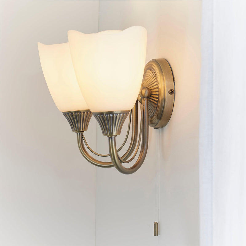 Endon Haughton Antique Brass Finish Twin Arm Wall Light Fitted to the Wall with Lights On