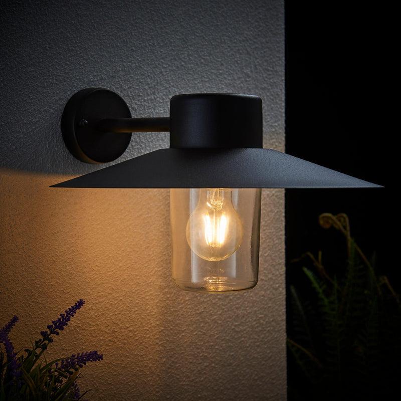 Endon Fenwick Textured Black Outdoor Wall Light 60798 - attached to outside wall at night with bulb lit