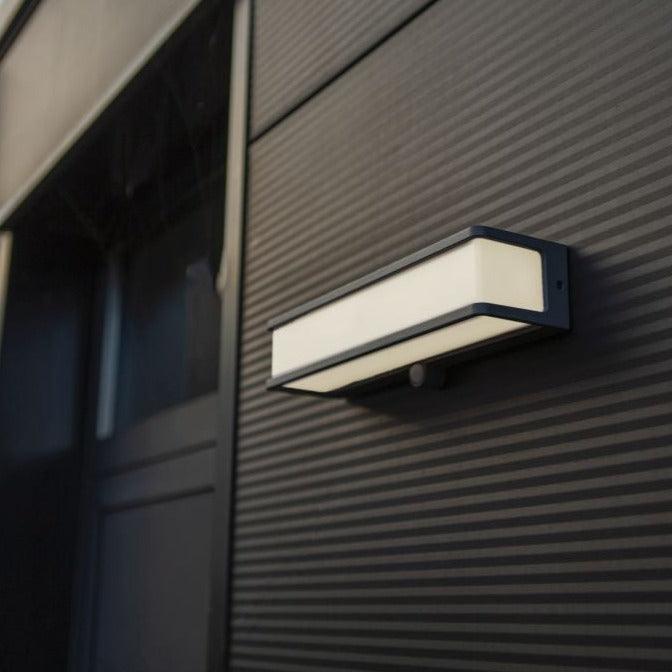 Lutec Doblo Solar LED Grey Wall Light - Motion Sensor 6943801125 attached to an outside wall