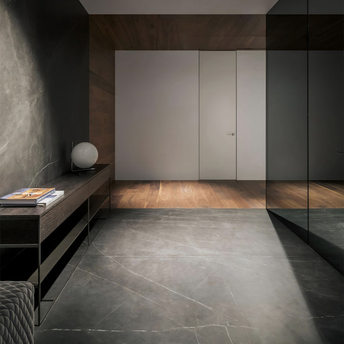 Sweden matt black flush ceiling light in a minimal hallway with stone floor and timber sideboard