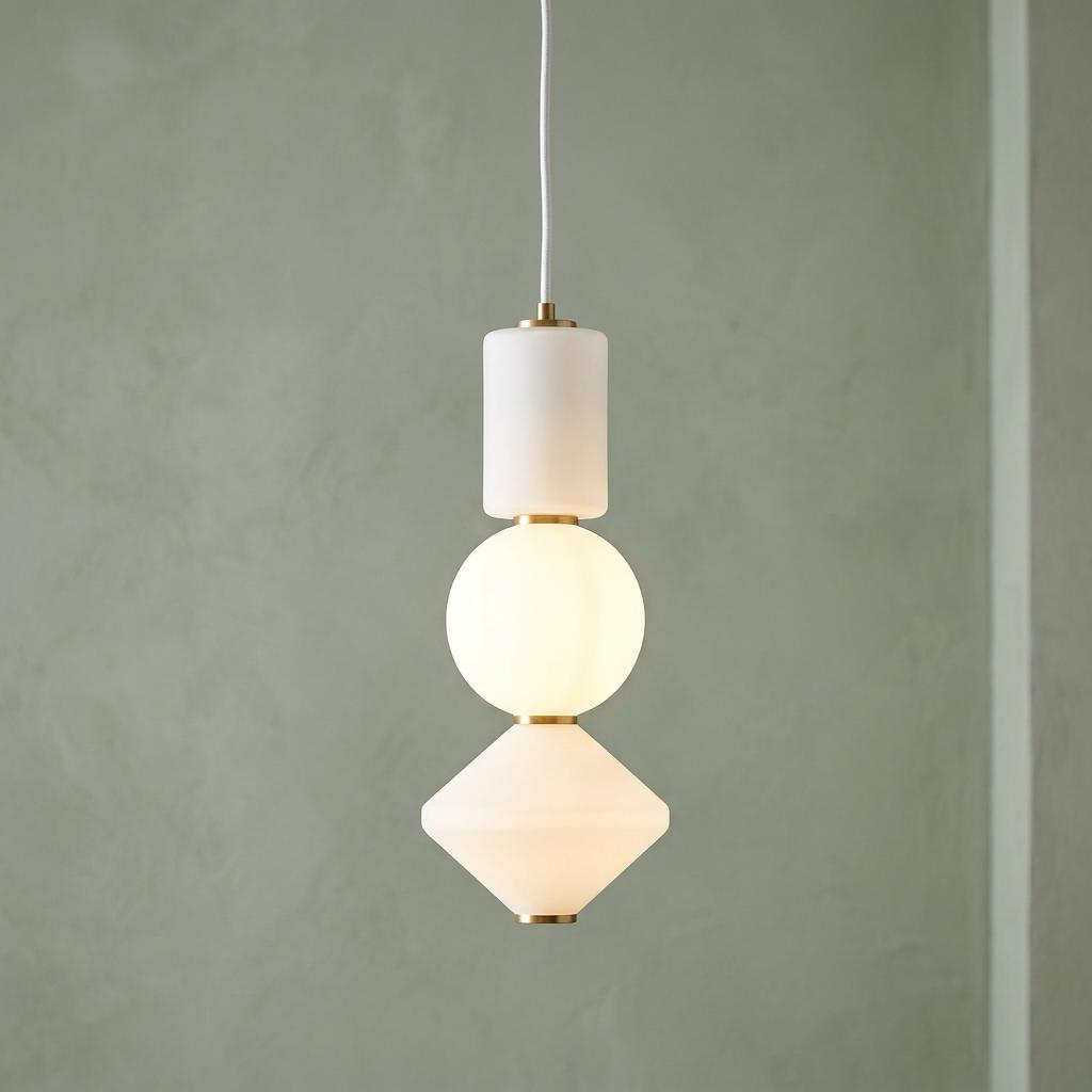 Modern pendant light with stacked cylindrical, spherical, and conical frosted glass shades and aged gold accents.