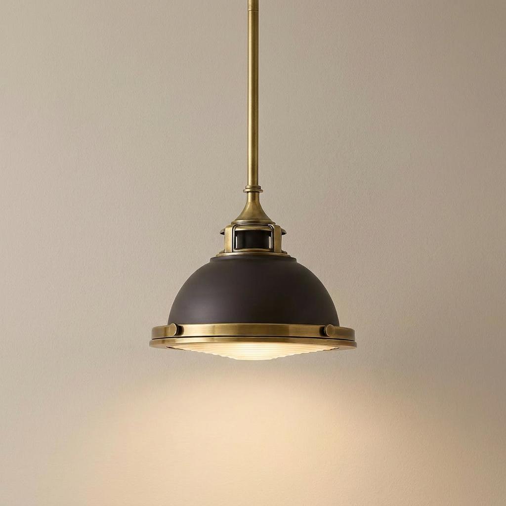 Amelia Bronze Mini Pendant Ceiling Light with a dark dome shade and brass accents on a neutral wall.