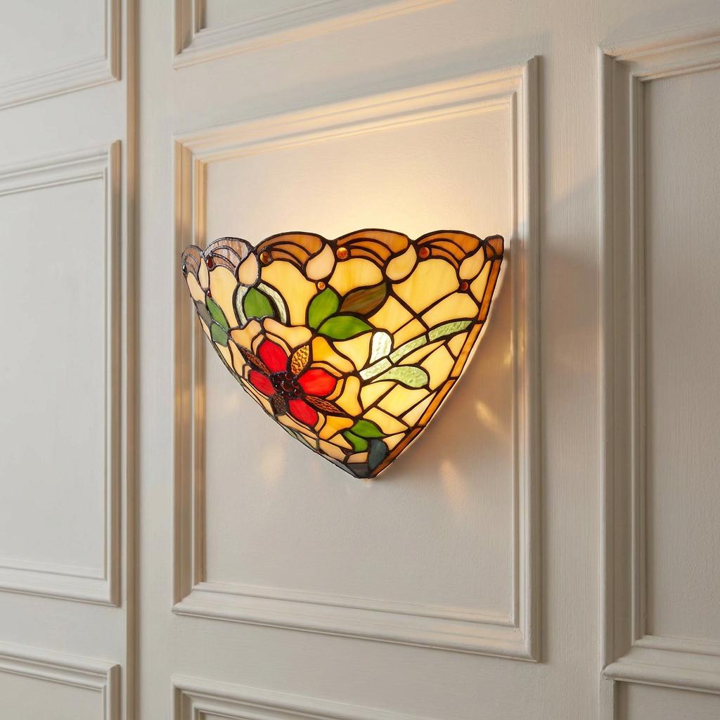 Angelique Tiffany wall light with a red floral stained glass design, mounted on a white paneled wall.