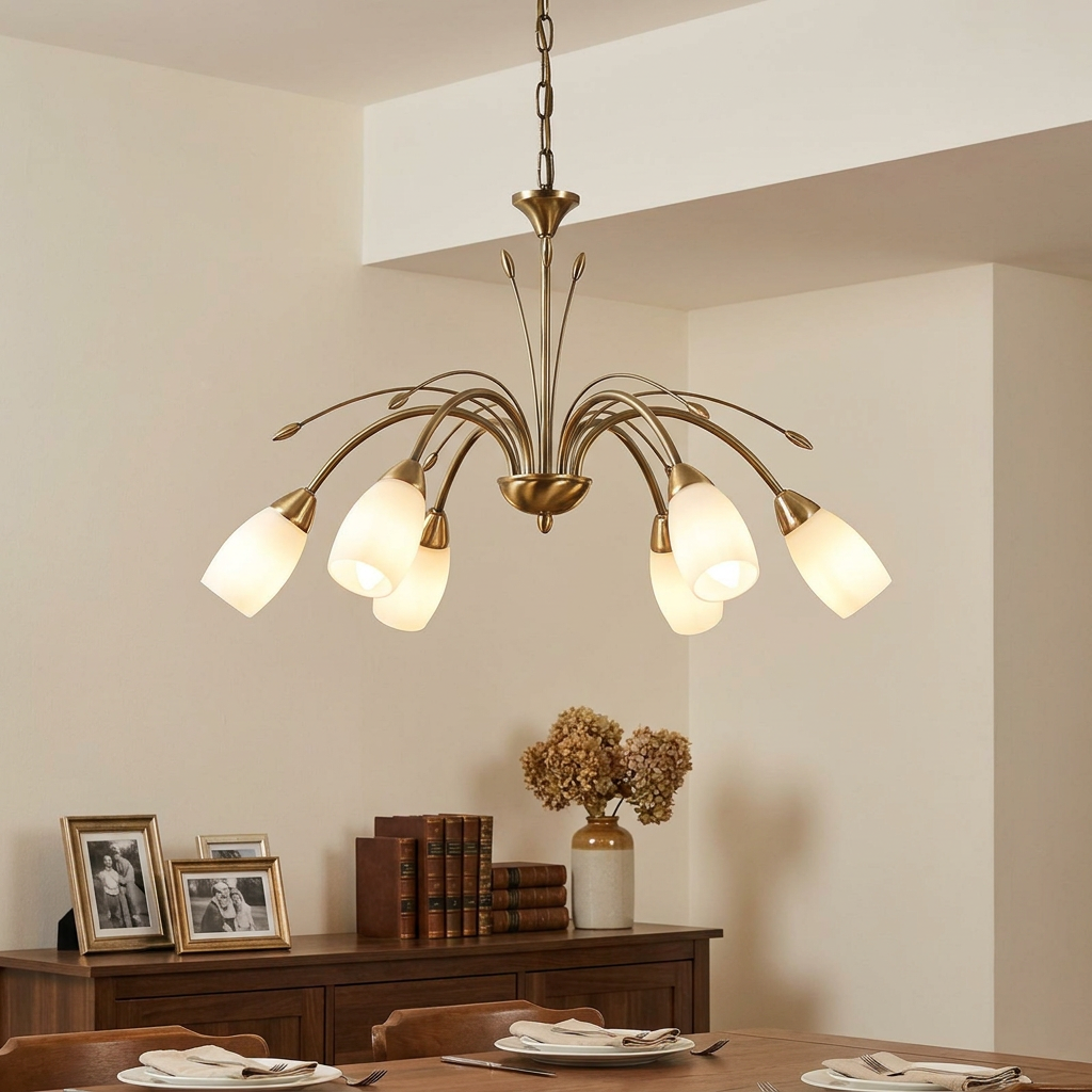 Antwerp 6-light antique brass chandelier with frosted glass shades hanging in a warm dining room.
