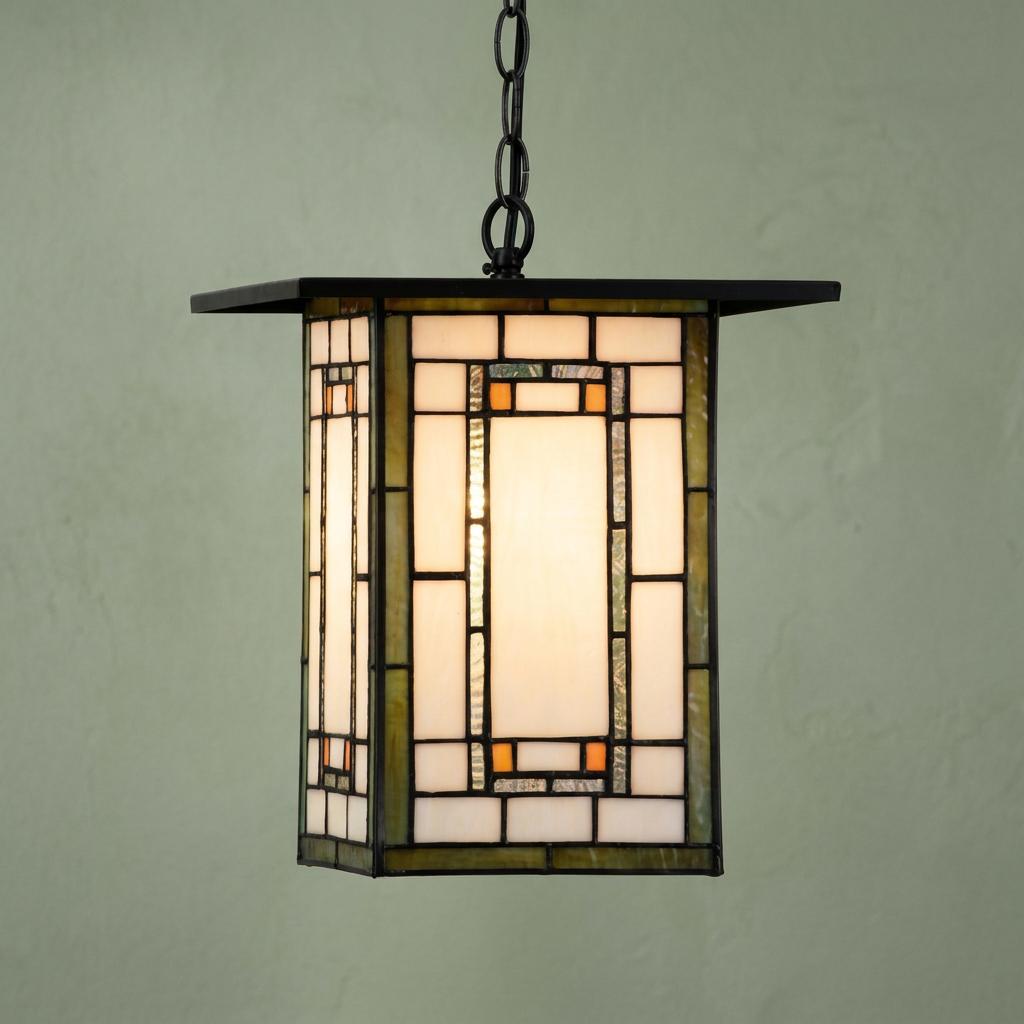 Mission-style Aragon Tiffany ceiling light with geometric stained glass panels and a black chain against a green wall.