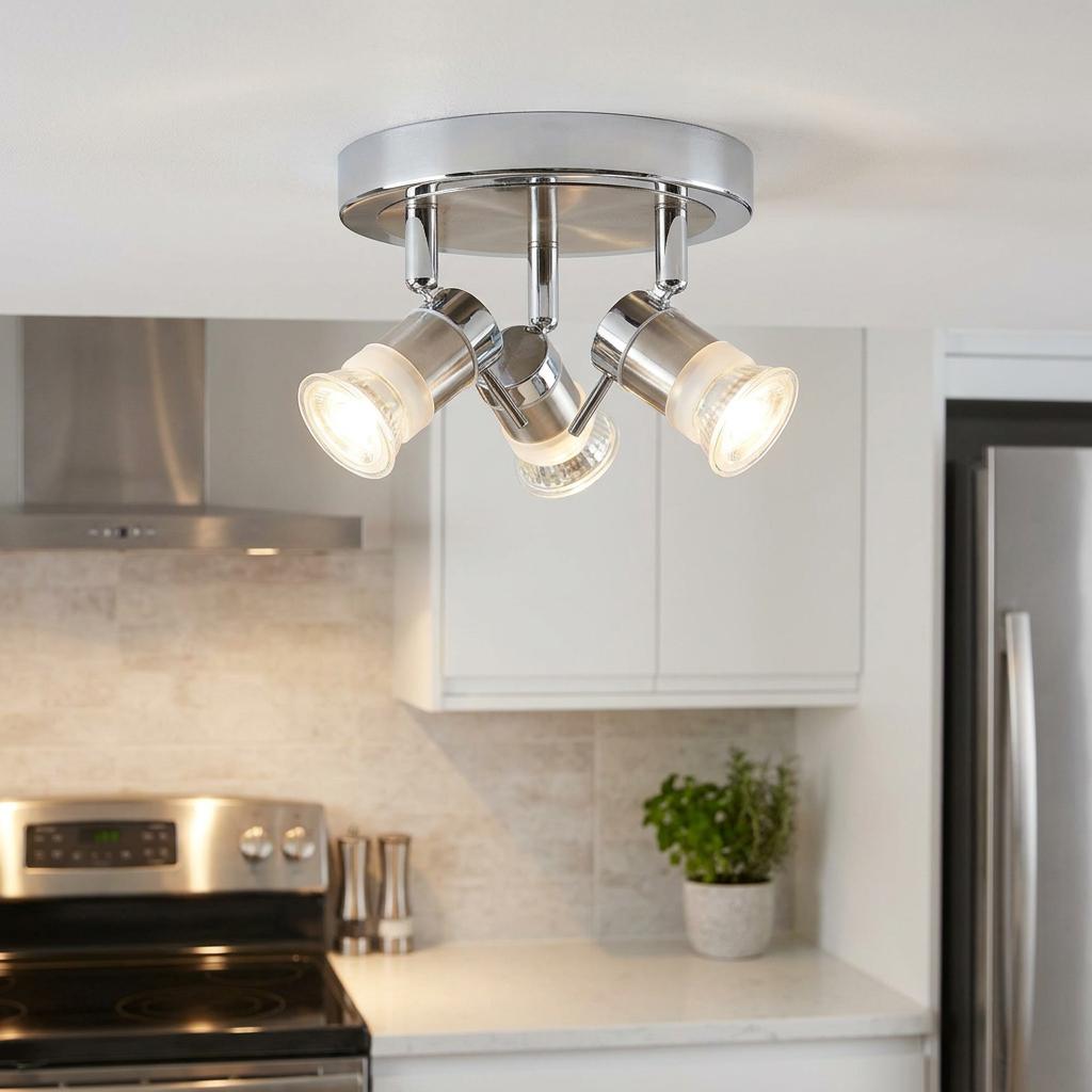 Modern chrome three-light adjustable flush spotlight fixture lit in a bright contemporary kitchen.