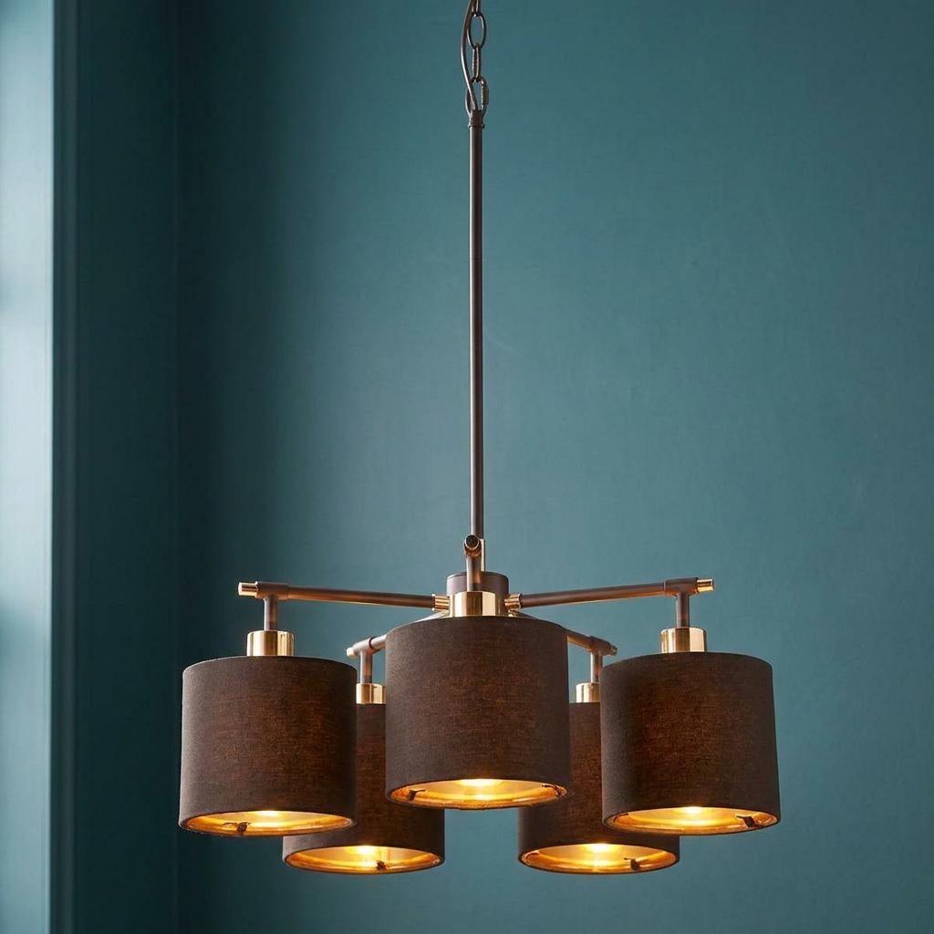 Balance 5-light chandelier featuring brown fabric drum shades and polished brass accents on a teal wall.