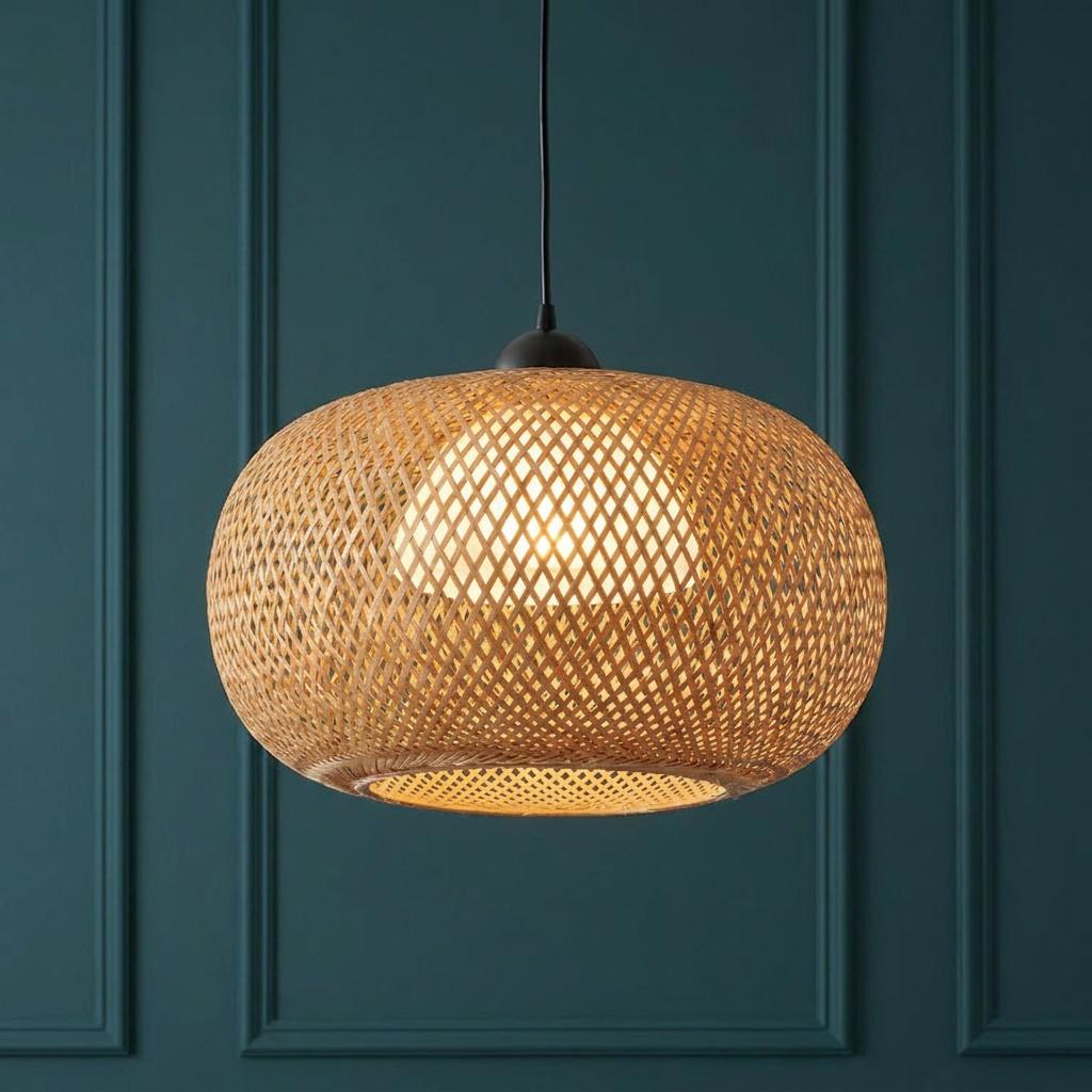 Bali Natural Bamboo Ceiling Pendant Light with a woven design glowing against a teal paneled wall.
