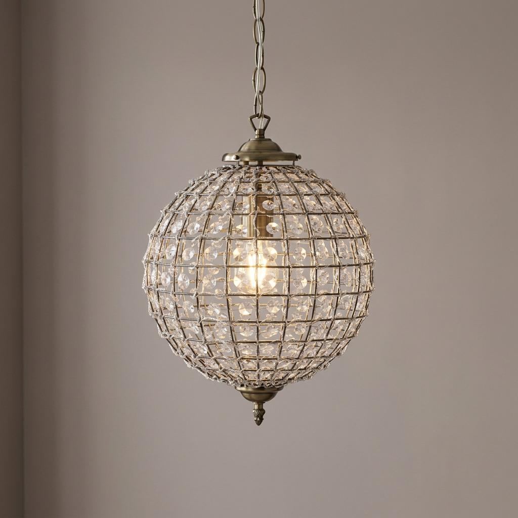 Antique chrome spherical pendant light with clear acrylic beads on a metal grid, suspended by a chain.