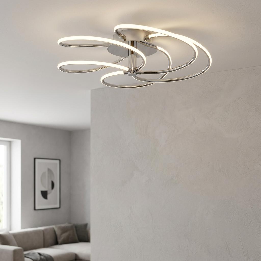 Bardot 5 Light LED Swirl Flush Chrome Ceiling Light with glowing loops mounted on a neutral ceiling.