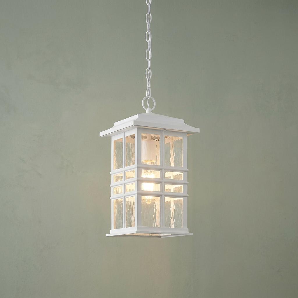 Beacon Square white outdoor chain lantern with hammered glass panels hanging against a pale green wall.