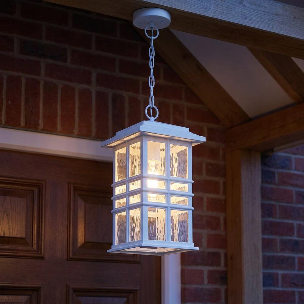 Illuminated white Beacon Square outdoor chain lantern with textured glass hanging from a porch ceiling.