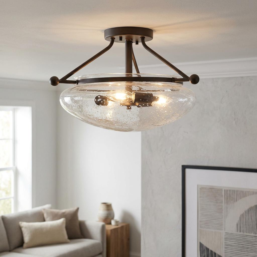 Belle 3-light bronze semi-flush ceiling light with a seeded glass shade illuminated in a modern living room.