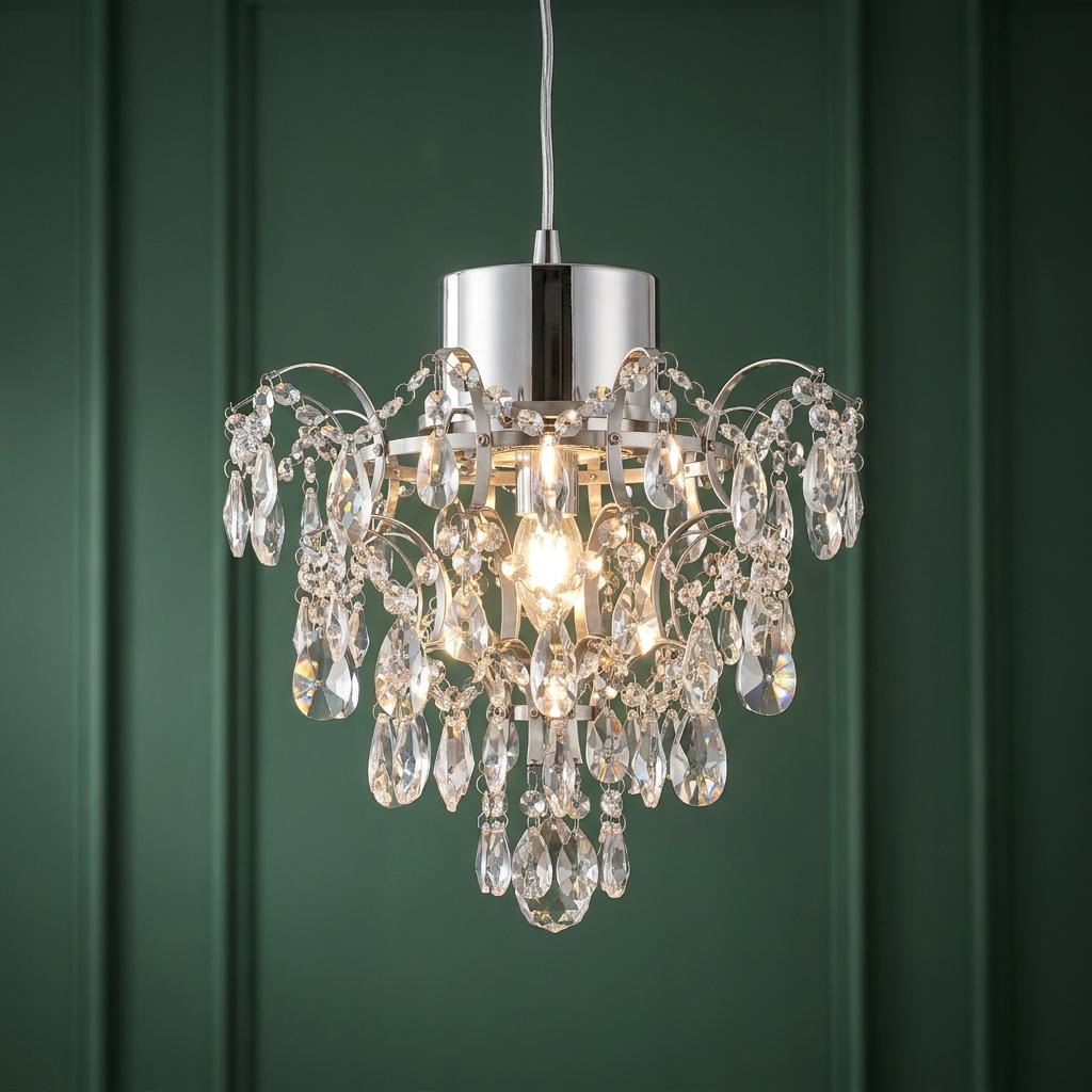 Belle chrome crystal chandelier illuminated against a dark green paneled wall.