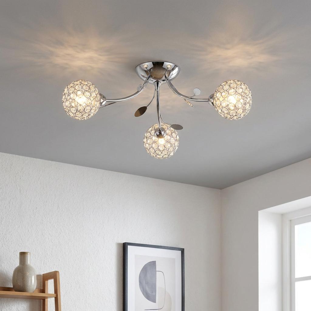 Bellis II 3-light semi-flush chrome ceiling fixture with crystal ball shades and leaf accents in a modern interior.
